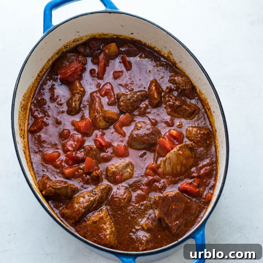 Simmering the beef with the chili paste mixture.