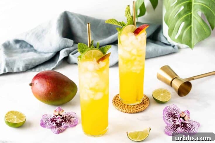 A couple of mango mojitos on a white table.