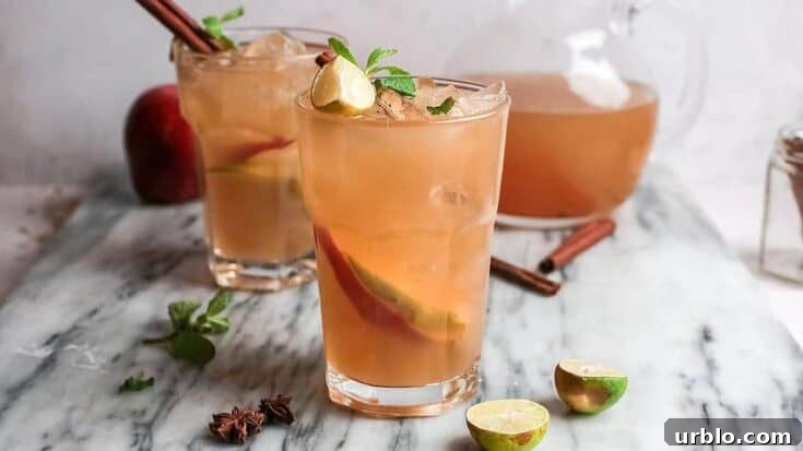 An apple cider mojito on a grey marble table.