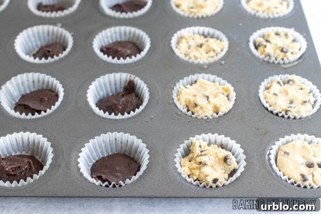 Decadent Brookie Bites Recipe: Chocolate Brownie + Cookie Bars 10 mini muffin tin with cookie dough on top of brownie batter