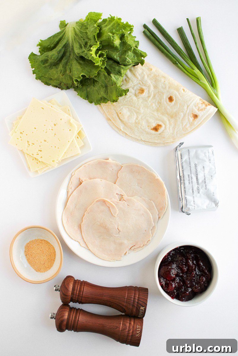 Cold Turkey and Cranberry Pinwheels for Leftovers 4 Turkey pinwheels ingredients laid out on counter prepared for the recipe.