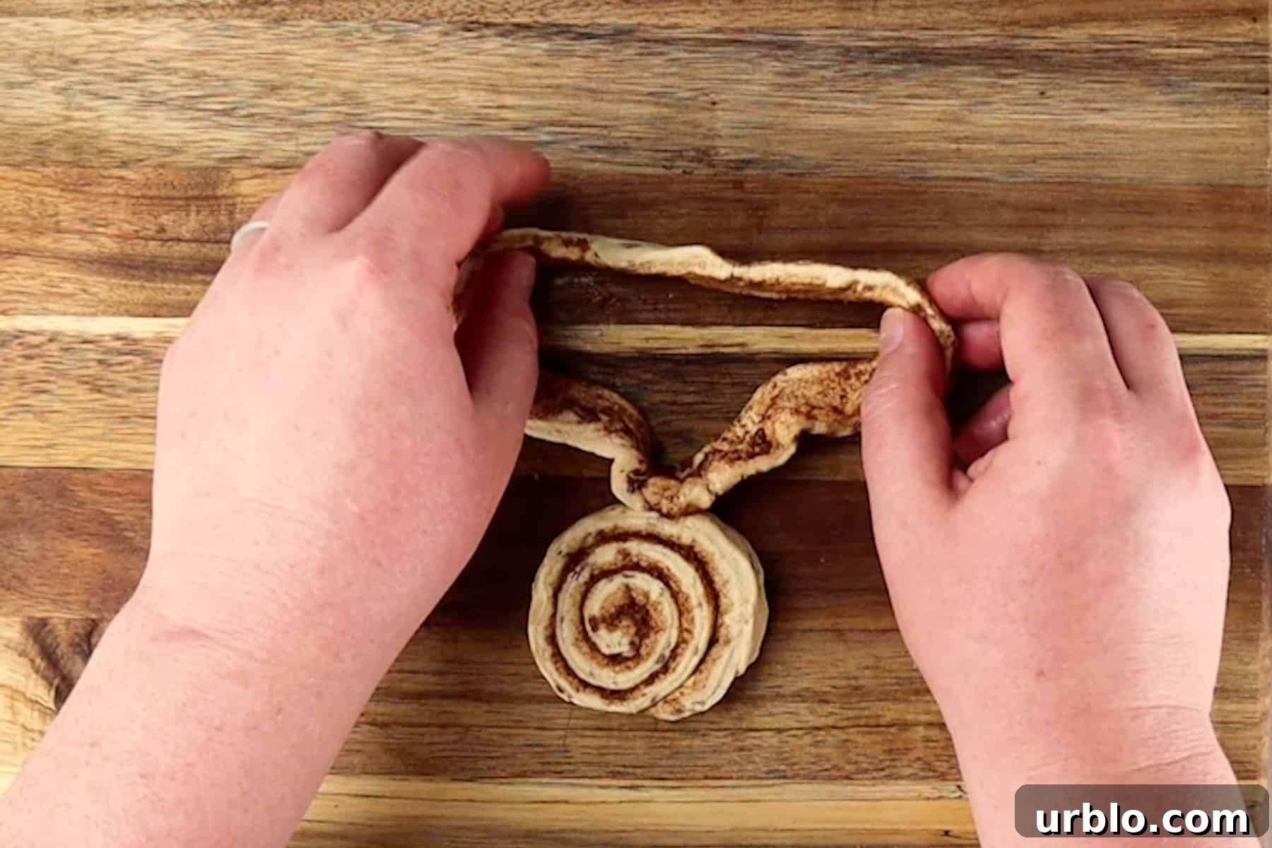 spreading cinnamon roll dough out to start shaping ears of bunny.