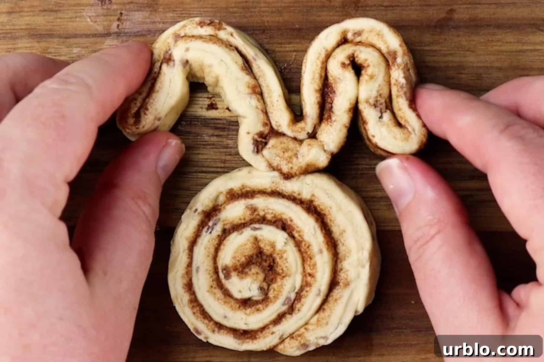 shaping ears for bunny out of cinnamon rolls.