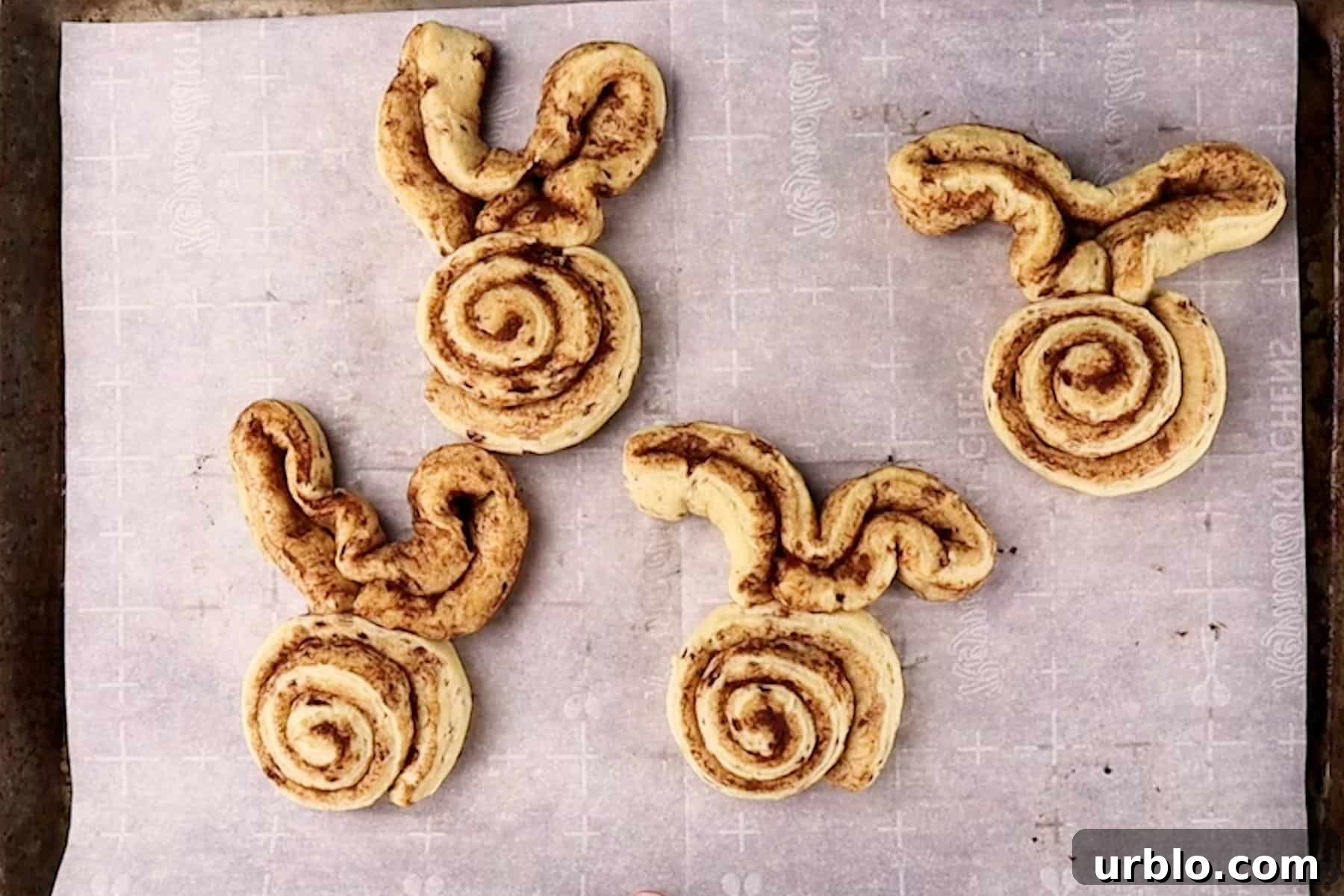 bunny cinnamon rolls after baking on baking sheet.