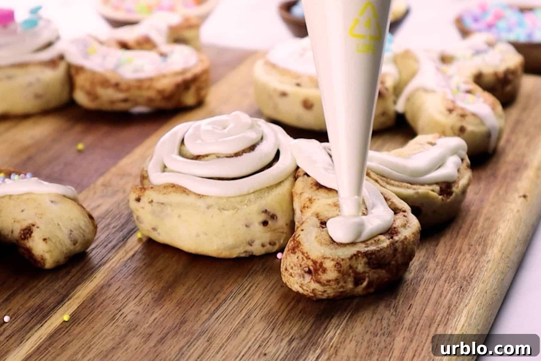 adding frosting to bunny cinnamon roll ears.