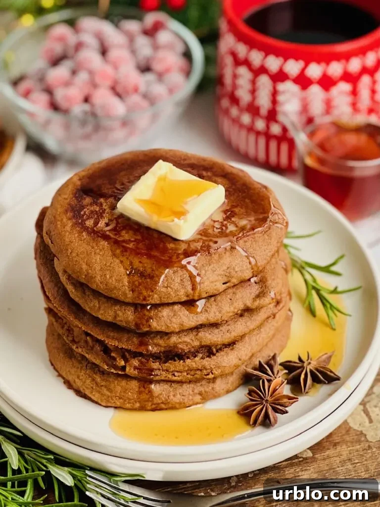 Pancakes with melting butter and syrup, forks nearby.