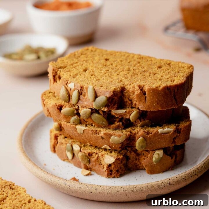 Slices of gluten-free pumpkin bread stacked on small plate.
