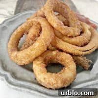 grey plate on a cutting board with crispy onion rings
