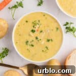 Creamy chicken soup in a bowl with parsley on top.