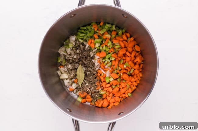 Vegetables and herbs in a large pot.