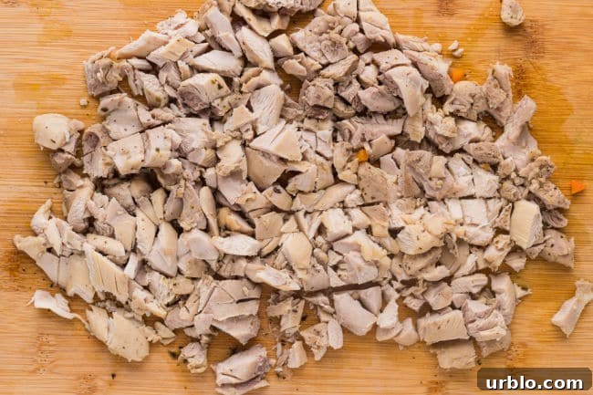 Chopped chicken on a cutting board.