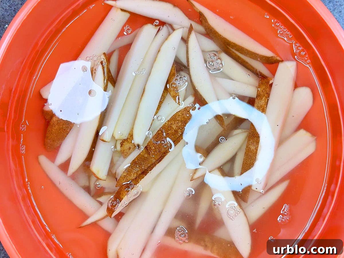Soaking cut potatoes in cold water.
