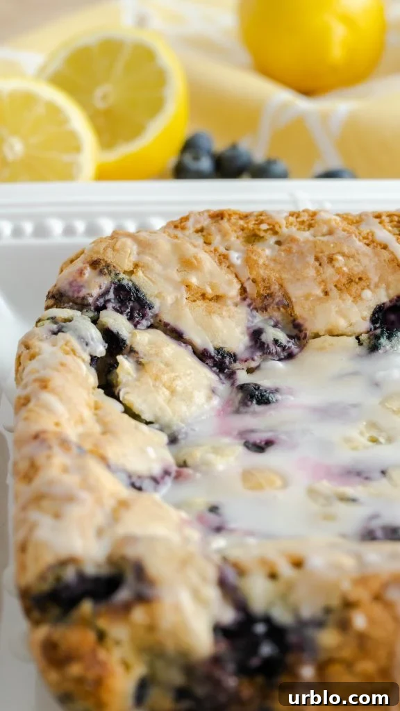 Uncut blueberry lemon bars on square serving platter. 