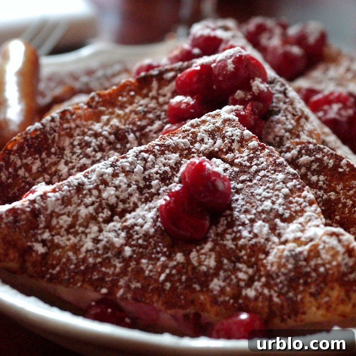 A plate of cherry stuffed french toast.