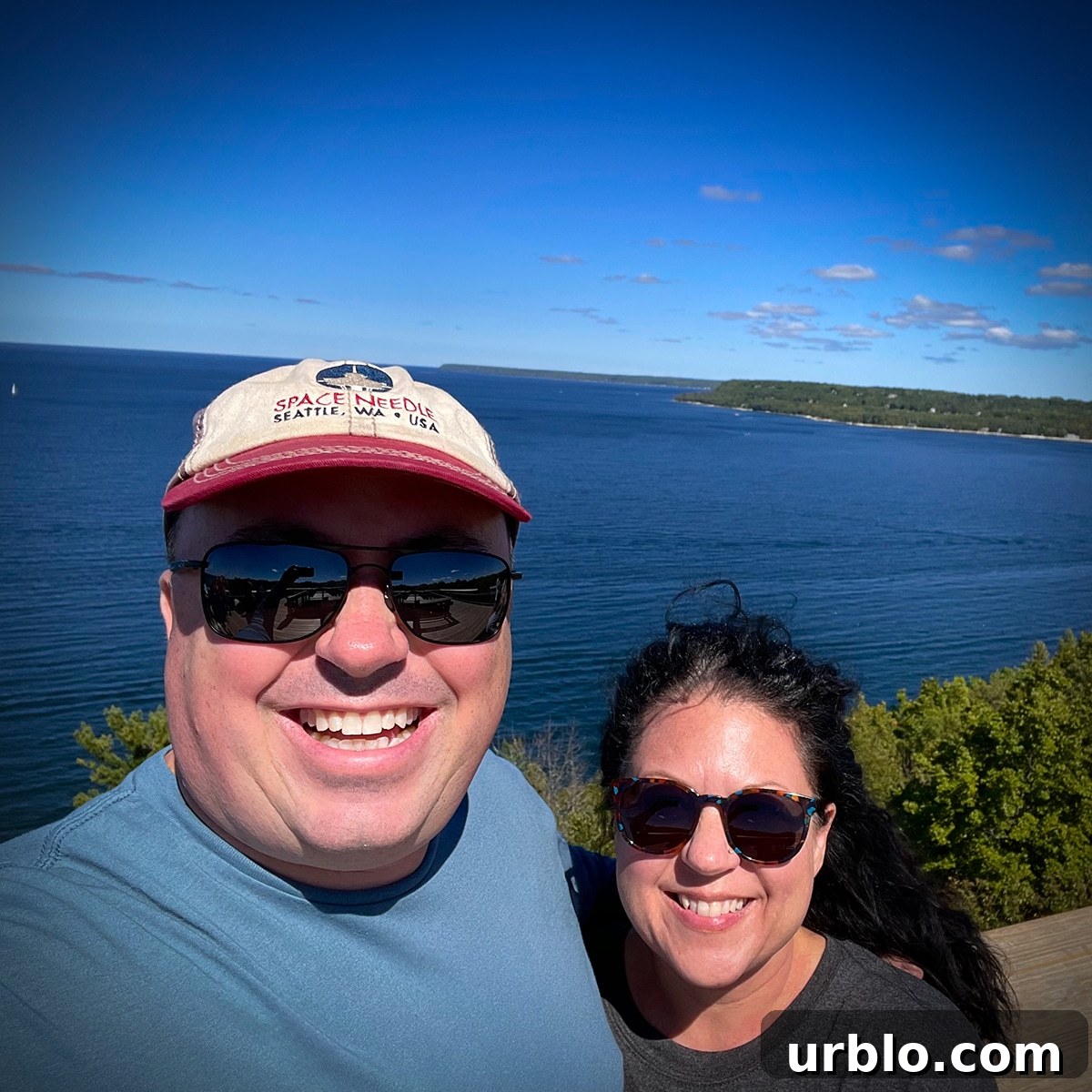 Steve and Rebecca Blackwell standing on the coast of Door County with Lake Michigan behind them.