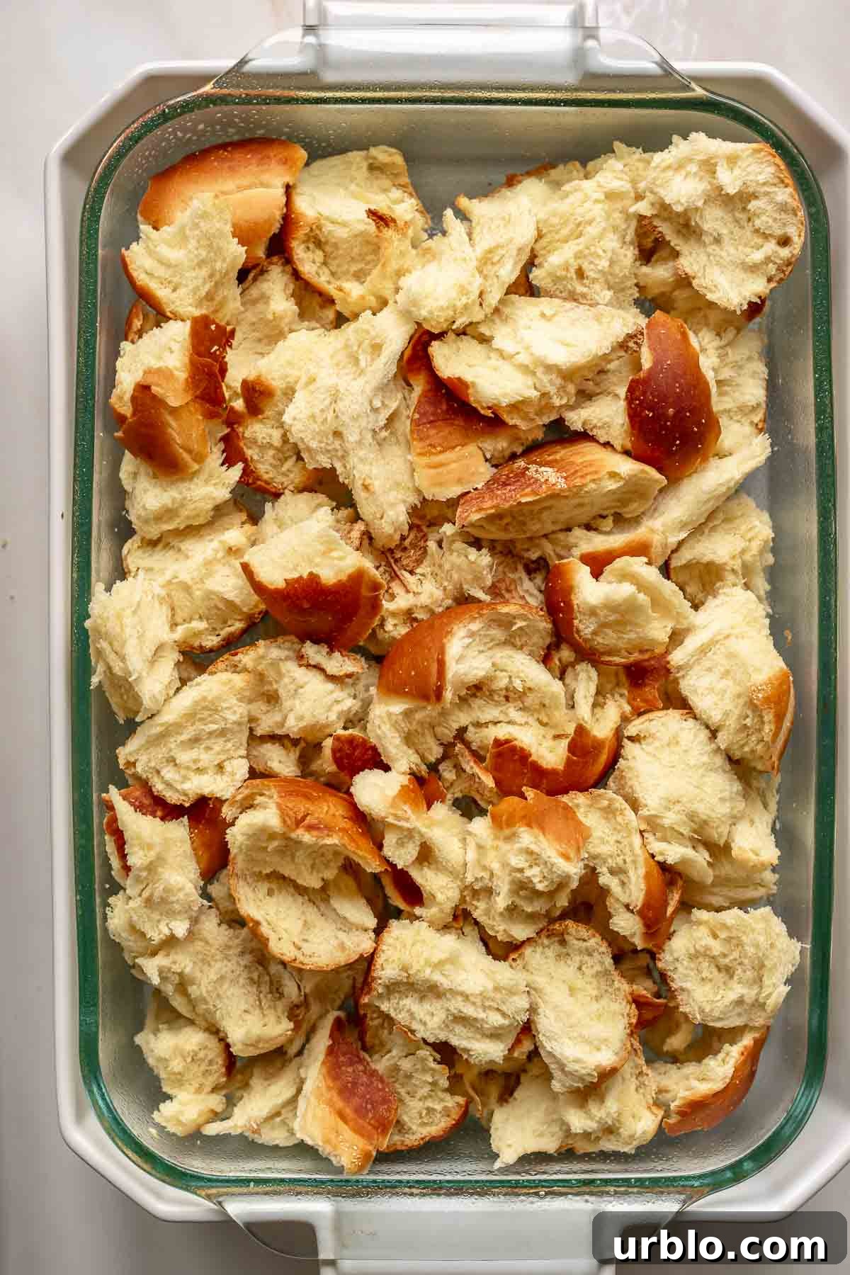 Challah bread pieces in a casserole dish.