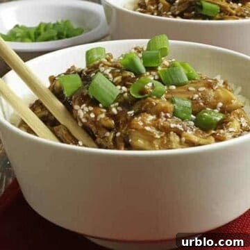 easy honey garlic chicken with sticky sauce in white bowl with chop sticks