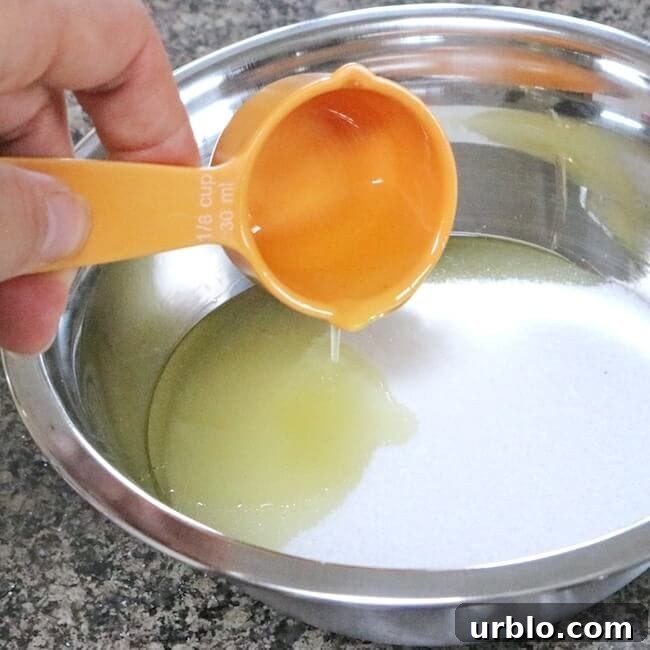 Adding honey to mixing bowl for homemade lip scrub