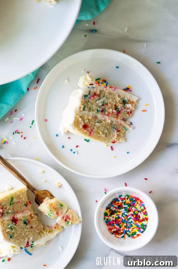 Moist Gluten-Free Birthday Cake Recipe 7 slices of funfetti cake on a white plate next to a bowl of sprinkles