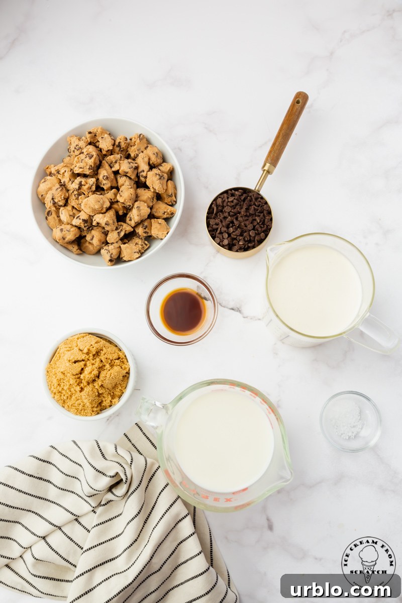 Ingredients needed for making cookie dough ice cream from scratch, all in separate bowls on a marble counter.