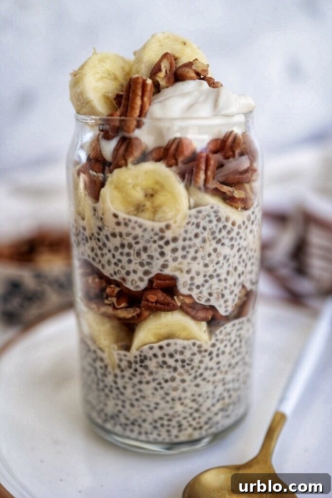 A jar of chia pudding layered with bananas and pecans.