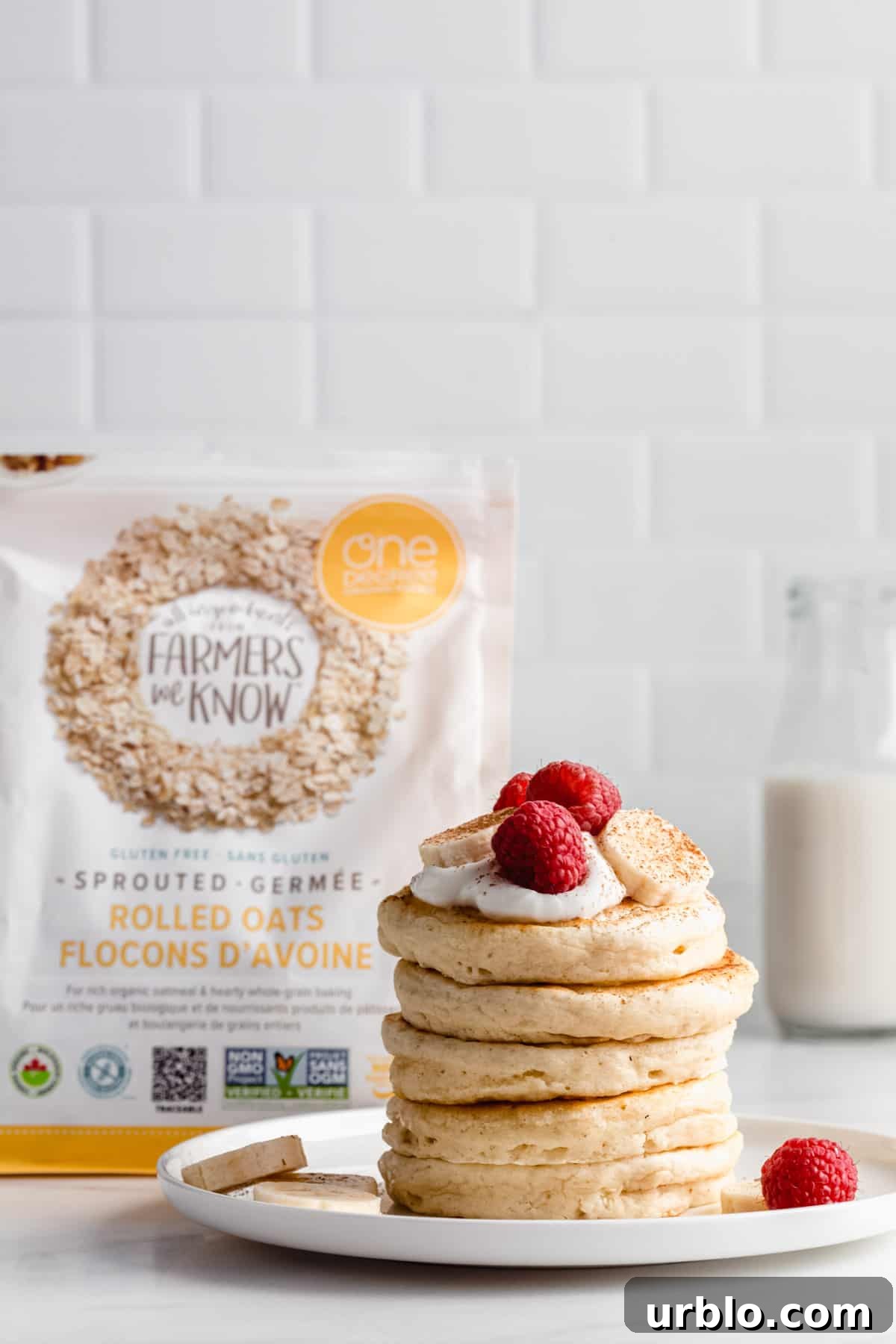 a stack of pancakes with a bag of one degree organic oats in the background