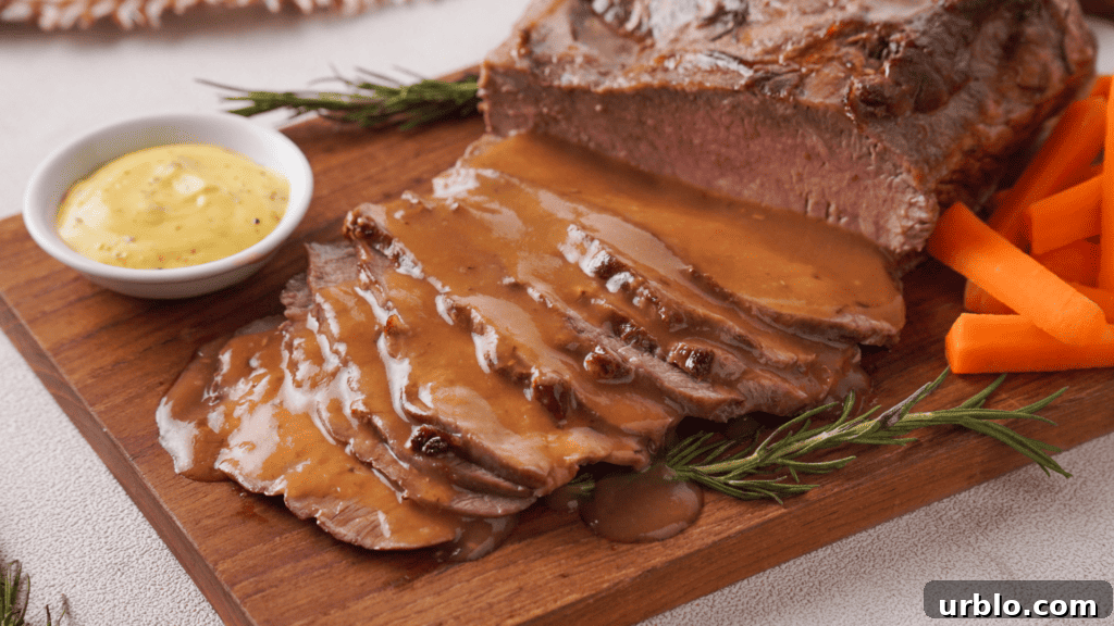 Air Fryer Roast Beef: Complete Guide to Tender, Juicy Results 2 Roast Beef with veggies, gravy and mustard on a wooden coaster