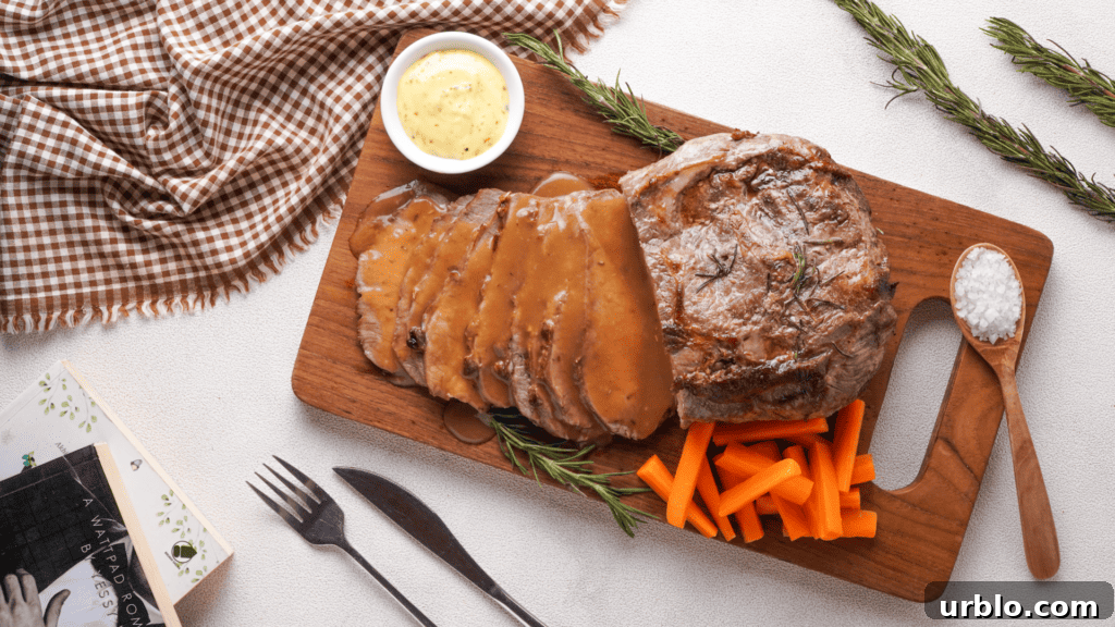 Air Fryer Roast Beef: Complete Guide to Tender, Juicy Results 3 Roast Beef with veggies, gravy and mustard on a wooden coaster made with air fryer.