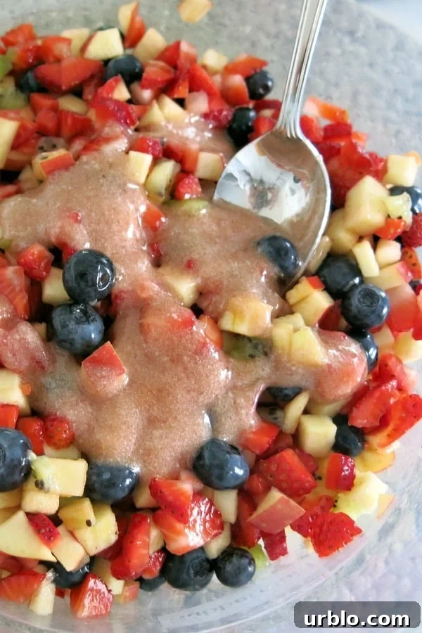 Low-Sugar Apple-Berry Salsa with Cinnamon Chips 7 Fruit salsa in bowl with jam and stevia glaze drizzled on top.