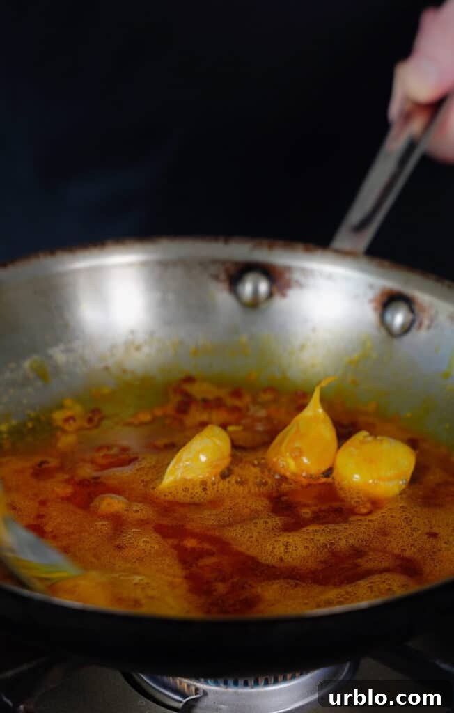 chicken oil with garlic in a frying pan