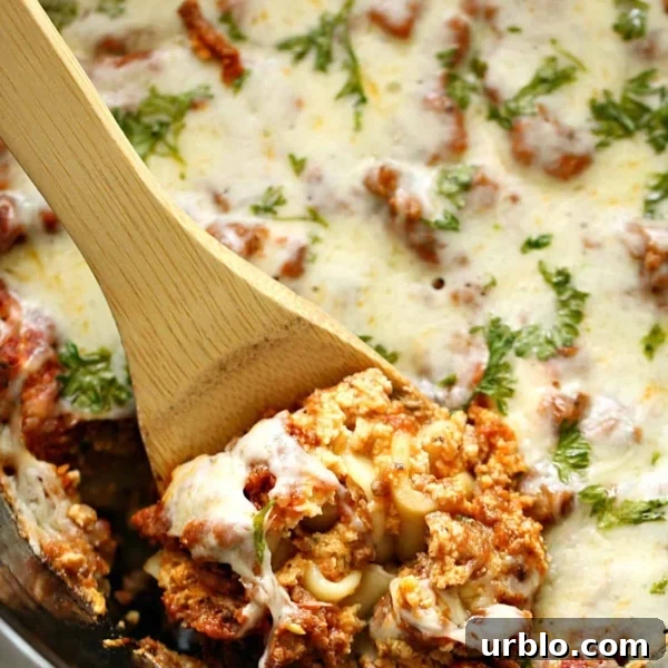 10 Make-Ahead Slow Cooker Freezer Meals Ready in 90 Minutes 5 Lasagna in the slow cooker being dished out with wooden spoon