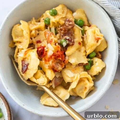 Bowl of creamy tortellini carbonara with bacon and parmesan