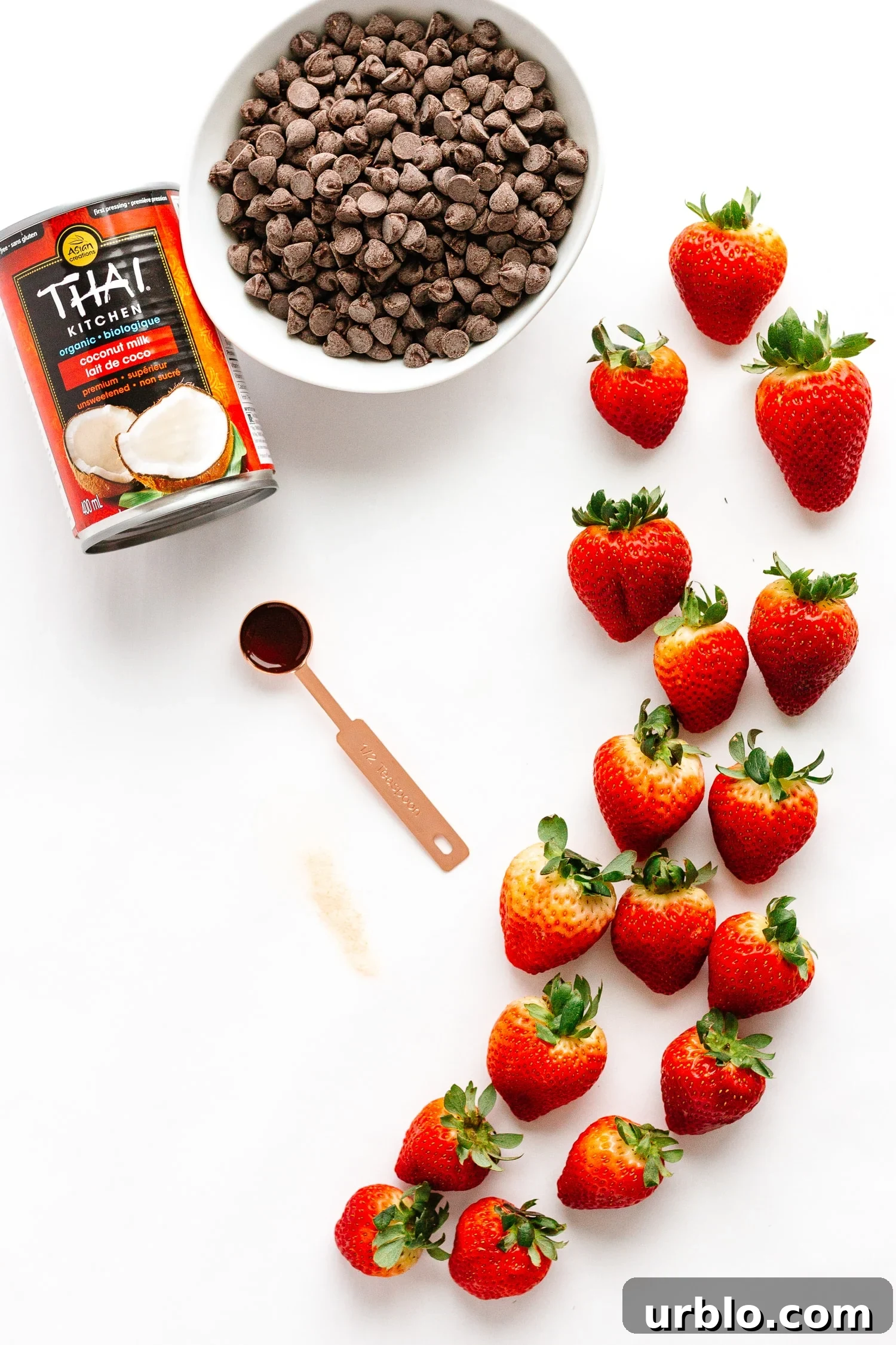 Flatlay showing ingredients needed to make chocolate coconut cream stuffed strawberries.