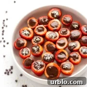 White bowl of chocolate coconut cream stuffed strawberries.