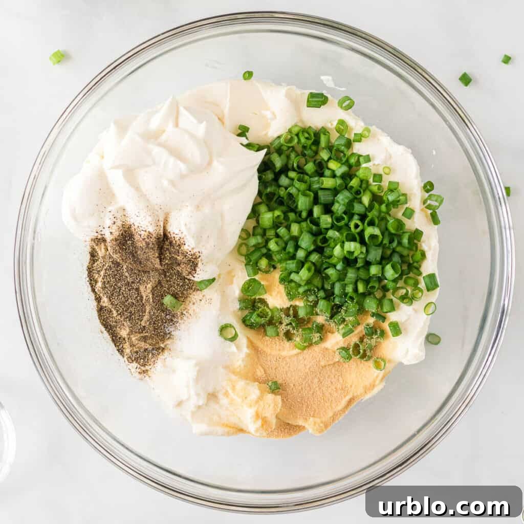 Classic Creamy Cheese Ball Recipe: Party Appetizer Guide 5 cream cheese, sour cream, green onions, and spices in a bowl