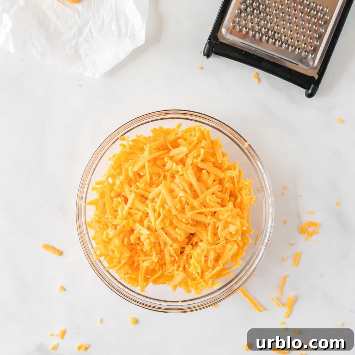 Classic Creamy Cheese Ball Recipe: Party Appetizer Guide 7 shredded cheddar cheese in a bowl