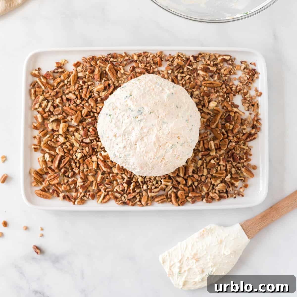 Classic Creamy Cheese Ball Recipe: Party Appetizer Guide 9 cheese ball on a plate of pecan pieces