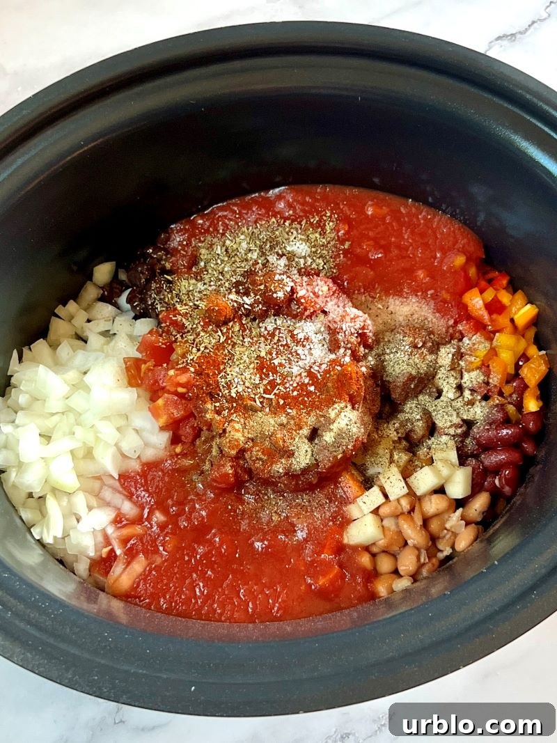 All the ingredients for slow cooker vegetarian chili combined in a large slow cooker. 
