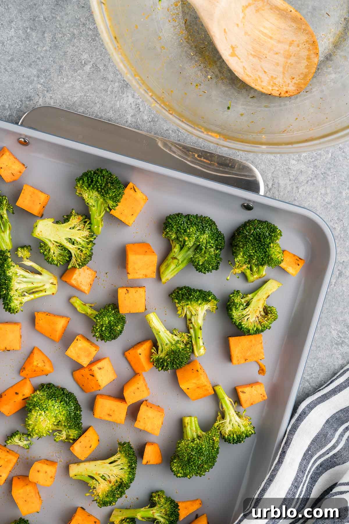 broccoli florets and sweet potatoes on a sheet pan