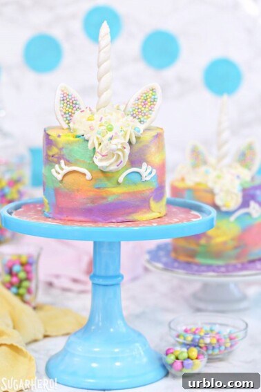 Very Hungry Caterpillar Birthday Cake Ideas and Decorating Tips 3 A mini unicorn cake on a blue cake stand.