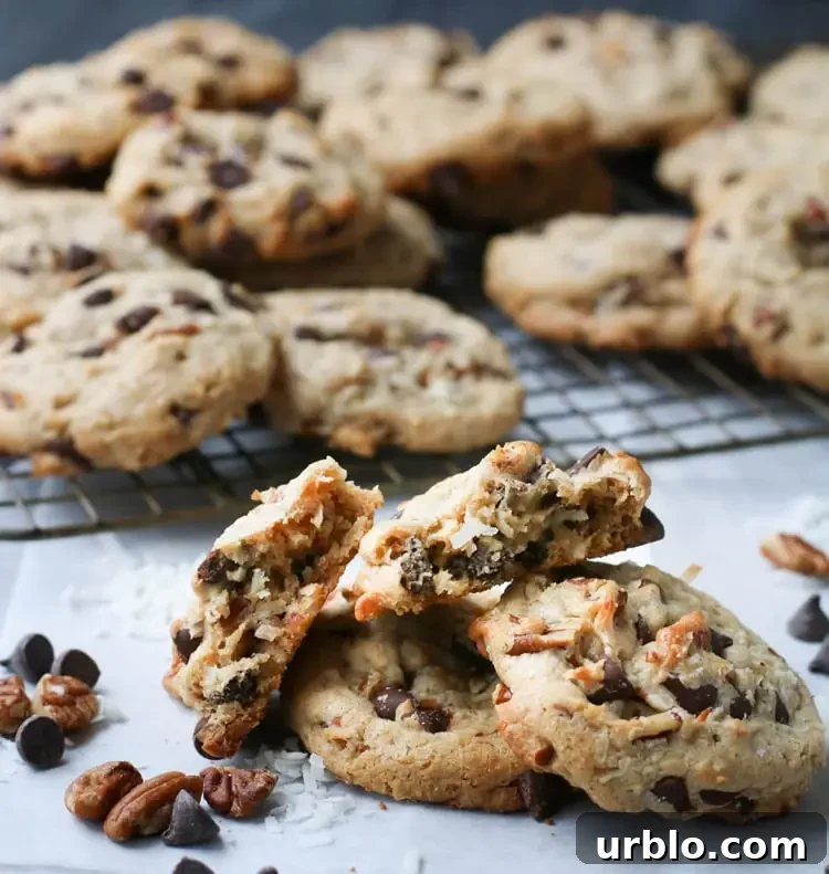a close up of a treasure cookie broken in half to expose the inside texture resting on top of other cookies