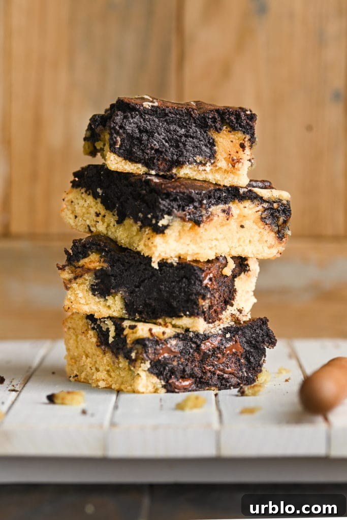 Fudgy Swirled Brownie-Blondie Bars: Chocolate-Vanilla Marble Treats 2 stack of brownie blondies on a white board