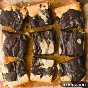 Fudgy Swirled Brownie-Blondie Bars: Chocolate-Vanilla Marble Treats 11 Fudgy swirled brownie blondies on parchment paper.