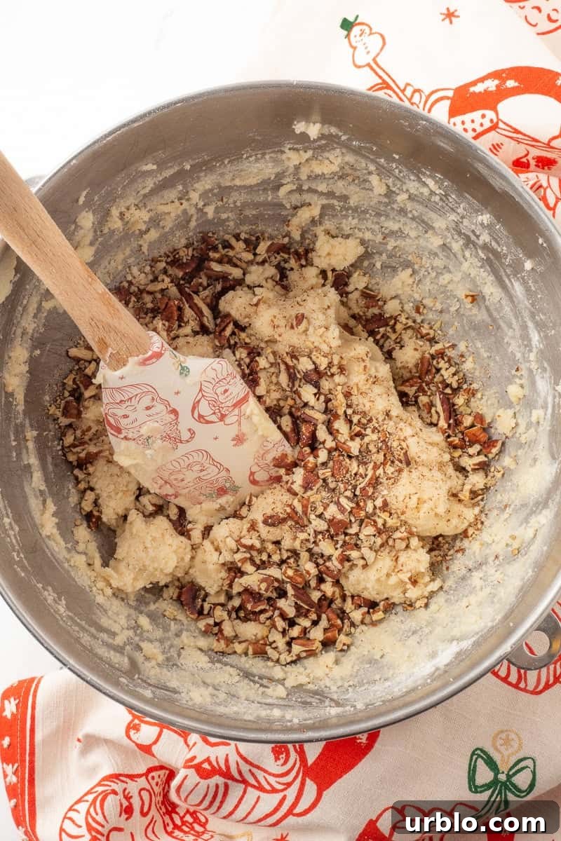 Chocolate-Dipped Pecan Sandies Cookies: Crunchy Butter Shortbread 7 Pecans are added to the cookie dough by hand with a spatula.