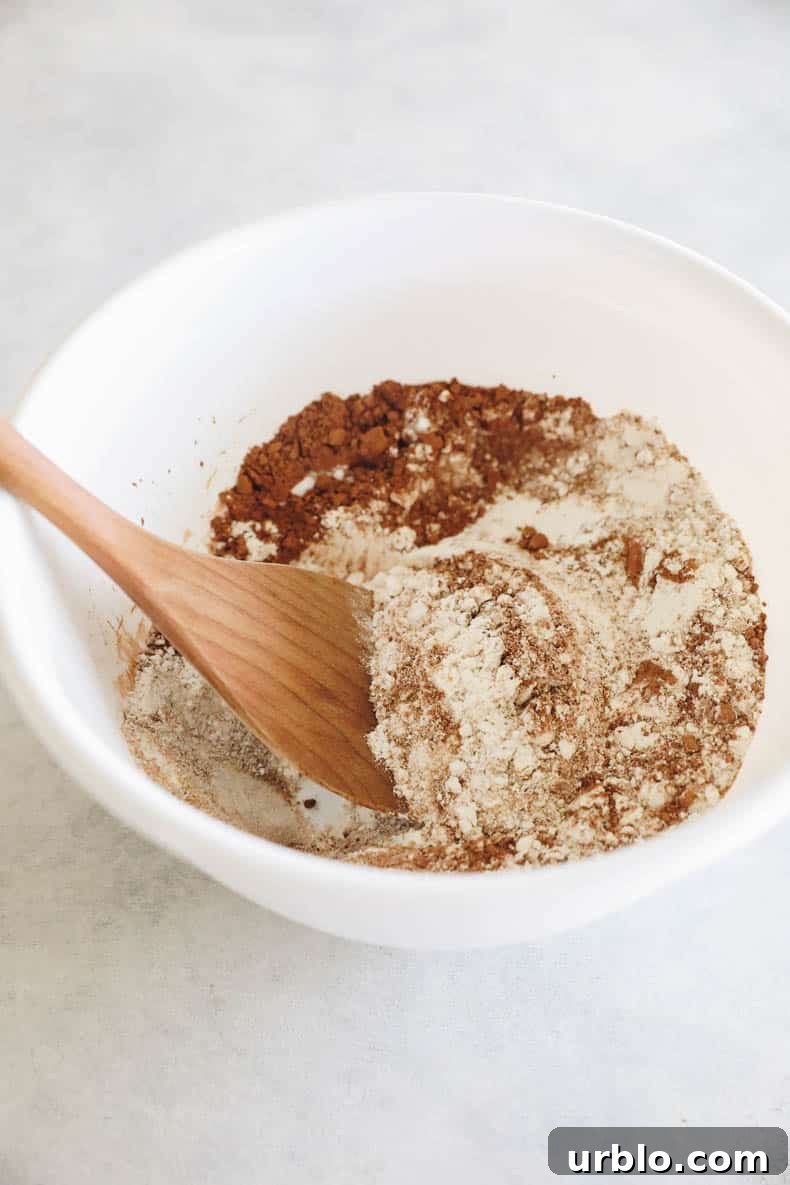 Dry ingredients for brownies in a white mixing bowl.