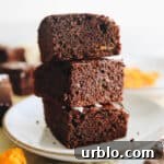 3 stacked sweet potato brownies on a white plate.