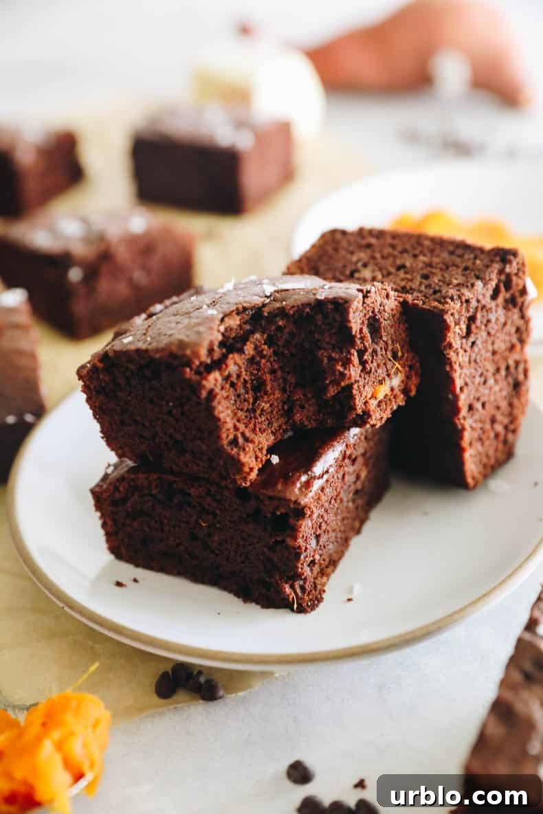 homemade sweet potato brownies on a white plate.