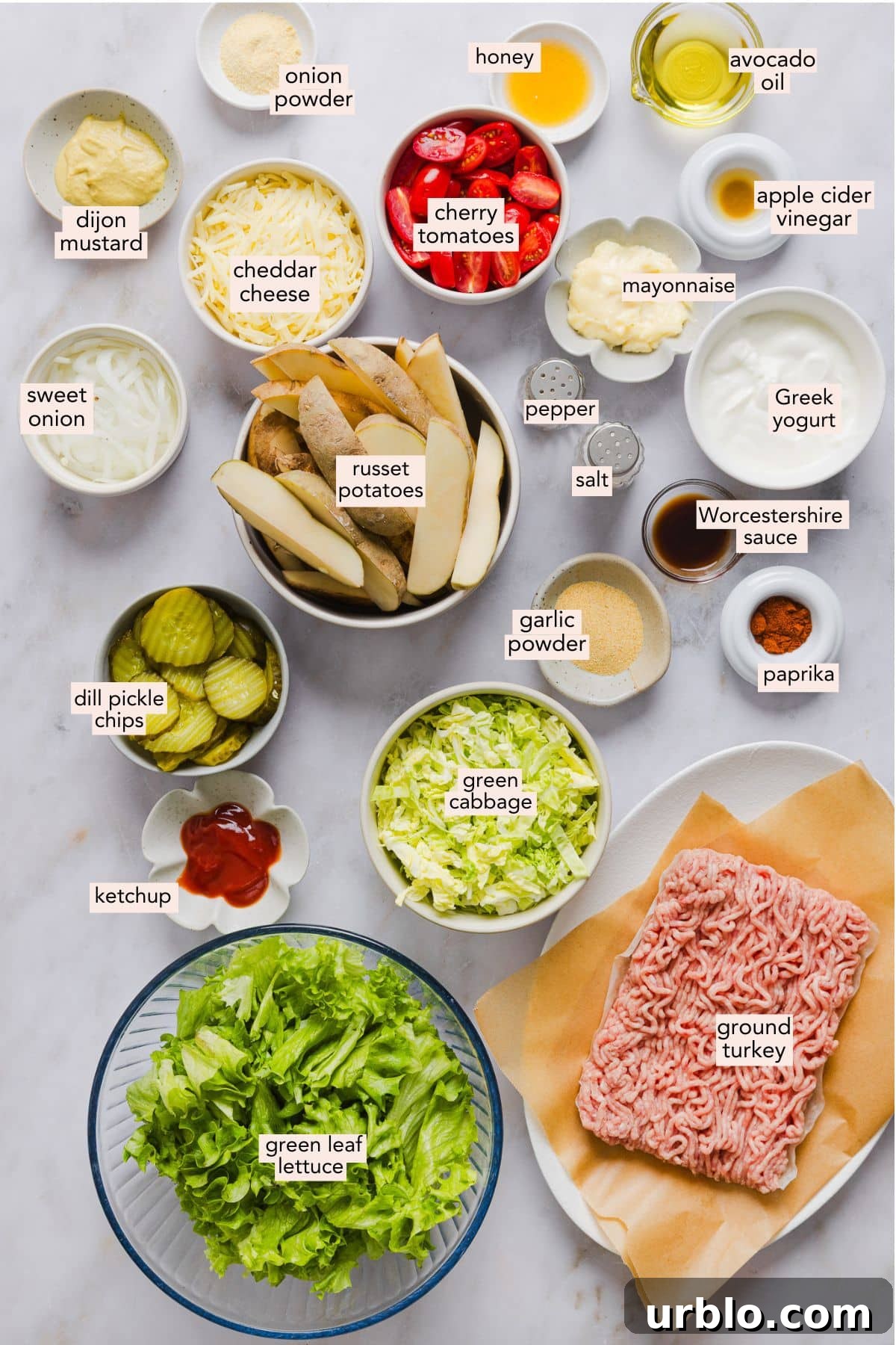 Ingredients for turkey burger bowls in individual bowls on a counter top.