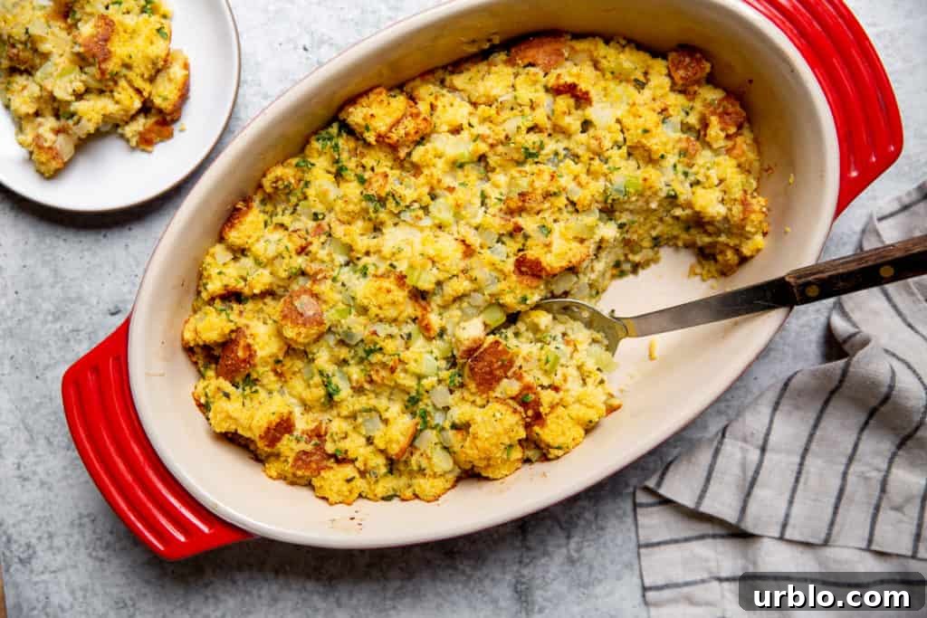Gluten-Free Cornbread Stuffing Recipe (Cornbread Dressing) 11 Gluten free stuffing in baking dish with a scoop removed.