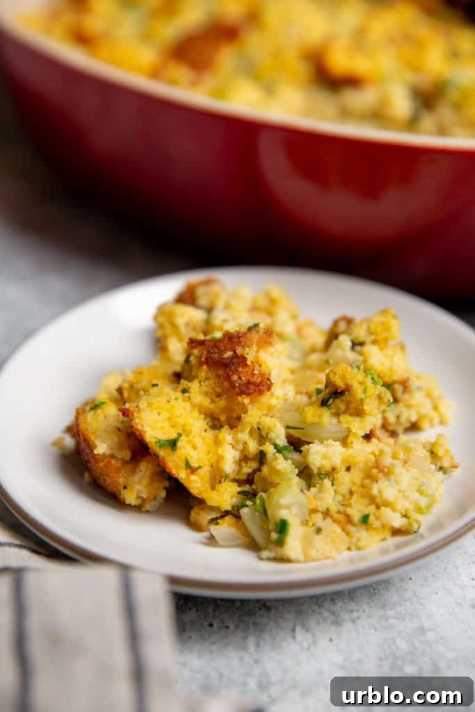 Gluten-Free Cornbread Stuffing Recipe (Cornbread Dressing) 3 A small plate of cornbread dressing, with the baking dish in the background.